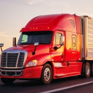 Truck loaded with cargo driving on a highway, symbolizing reliable road freight services for transporting goods.